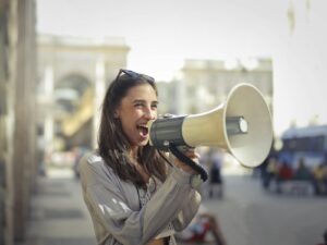 Email Marketing Caribbean Business Cheerful young woman screaming into megaphone