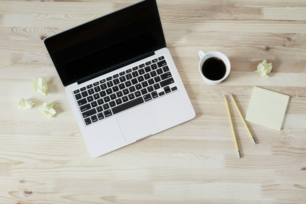 Email list building turned off MacBook Pro beside white ceramic mug filled with coffee