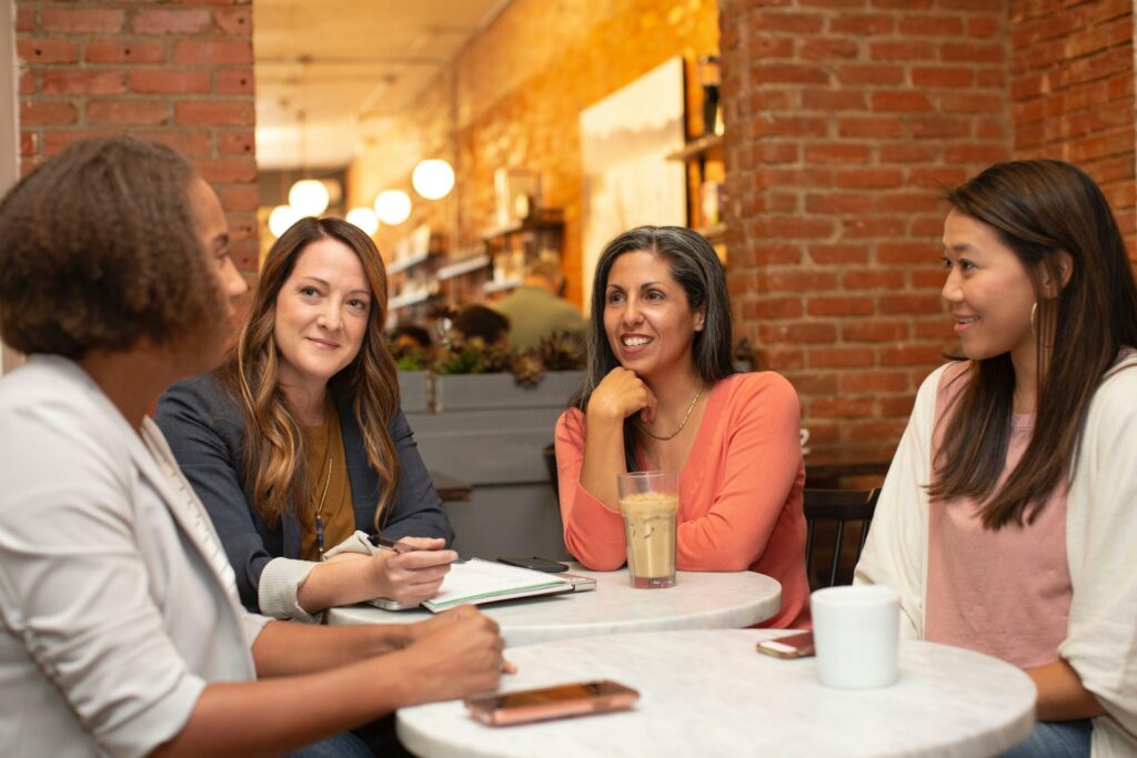 support system for woman in black jacket sitting beside woman in white blazer