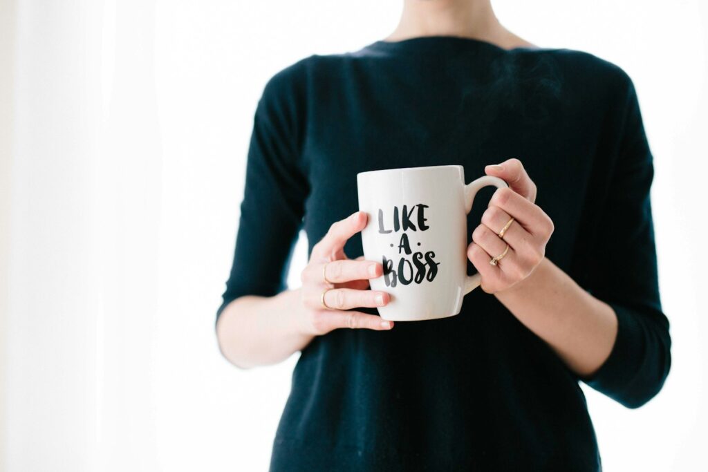 Momtrepreneur woman holding white mug while standing